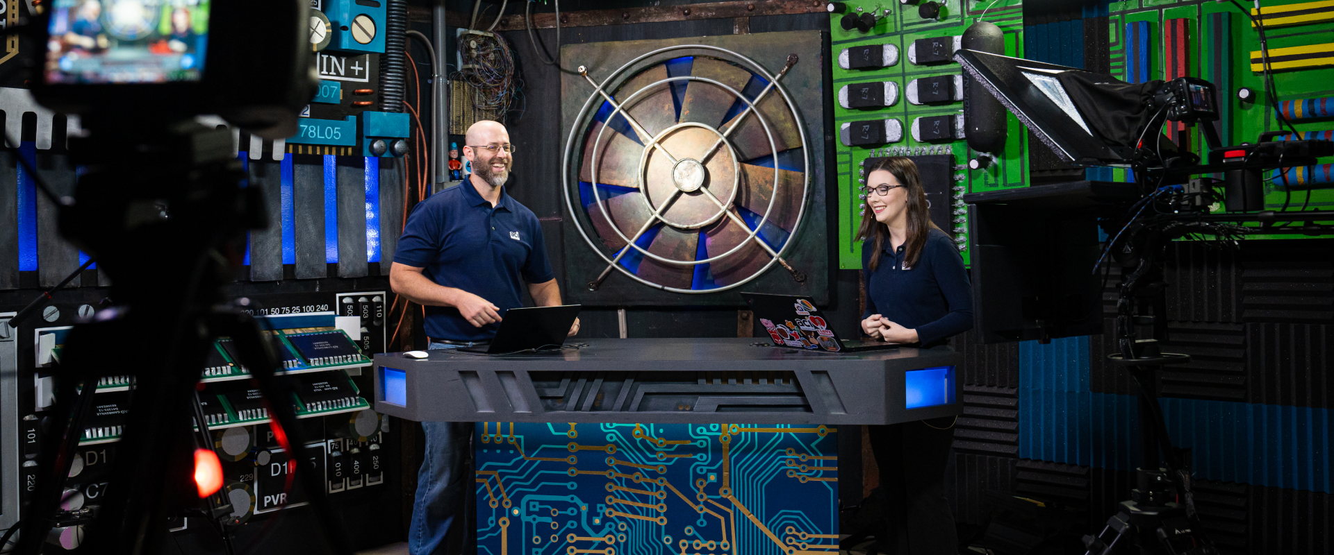 two people talking in studio with lights in foreground