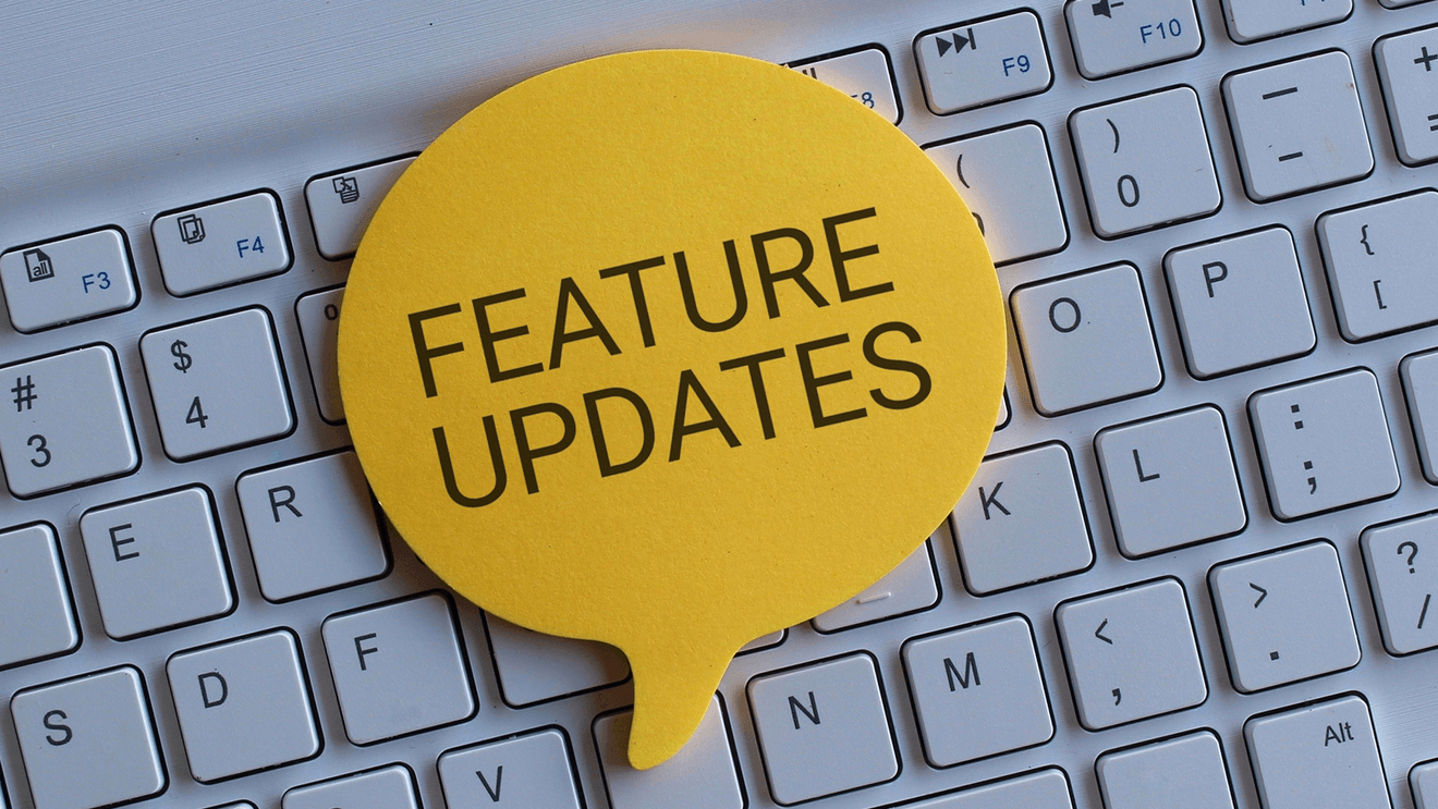 Yellow speech bubble that says feature updates on a keyboard