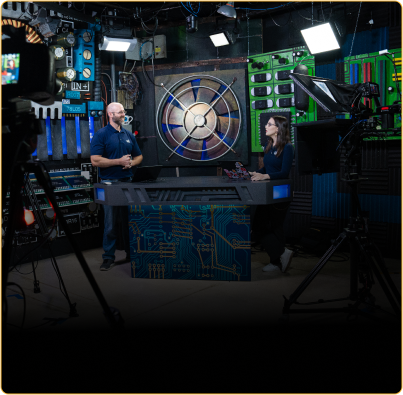 two people talking in studio with lights in foreground