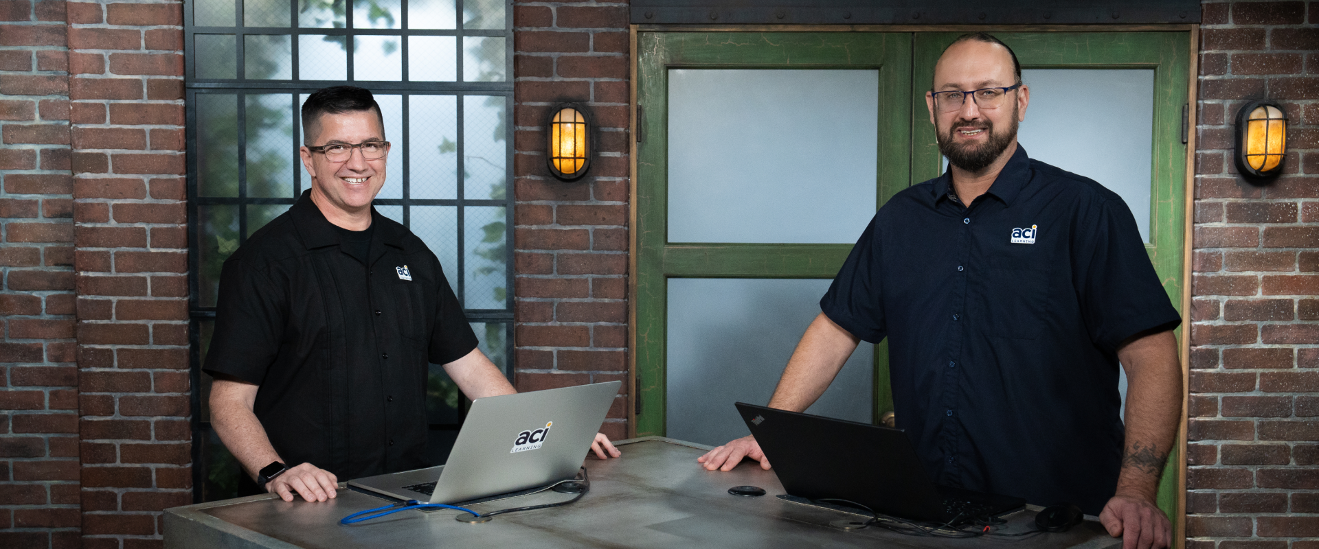 two people with laptops in studio