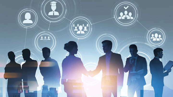 silhouettes of business people shaking hands and on devices with icons floating around