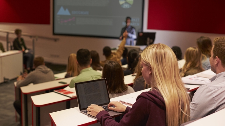 Student using a laptop whilst attending a class