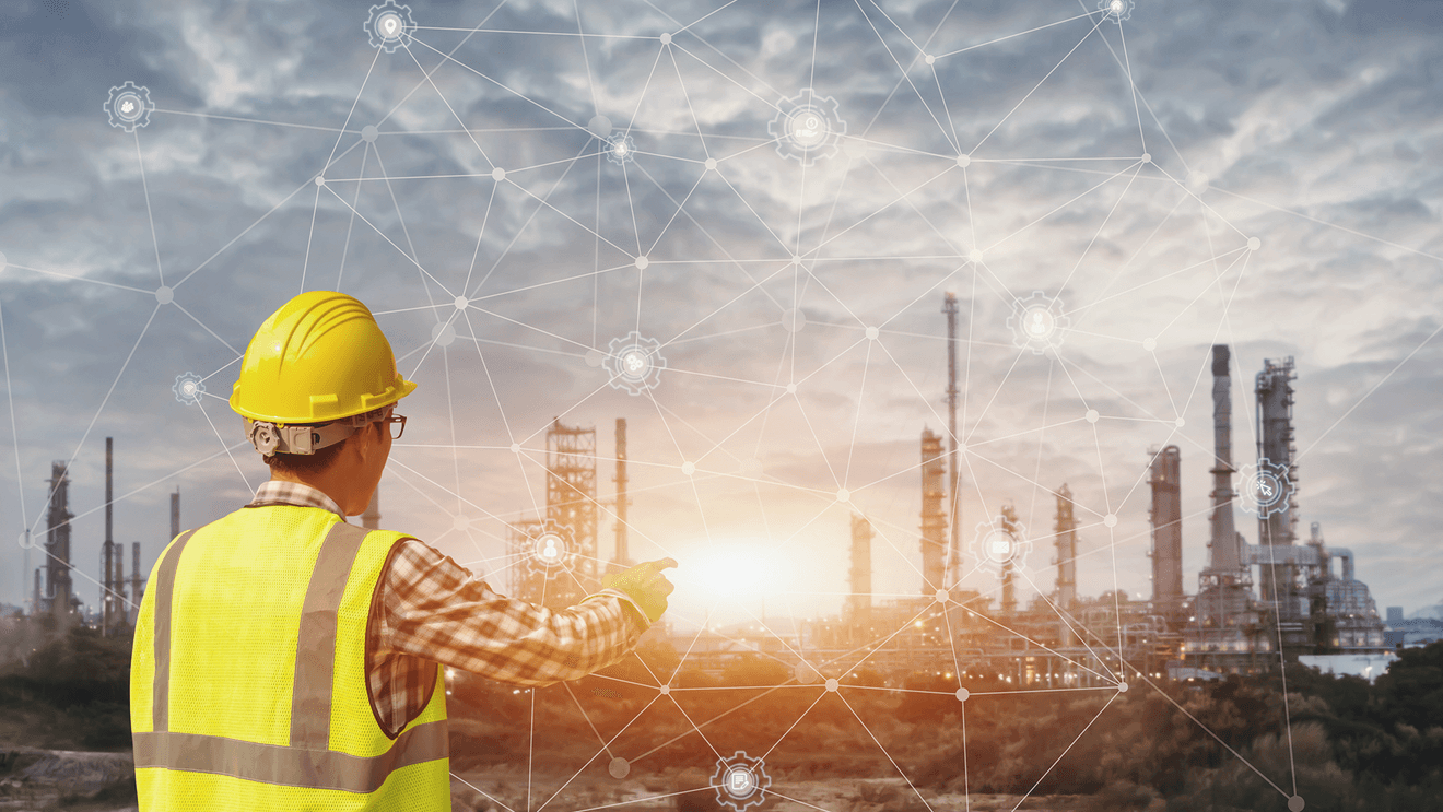 man in yellow construction vest and helmet looking at cityscape